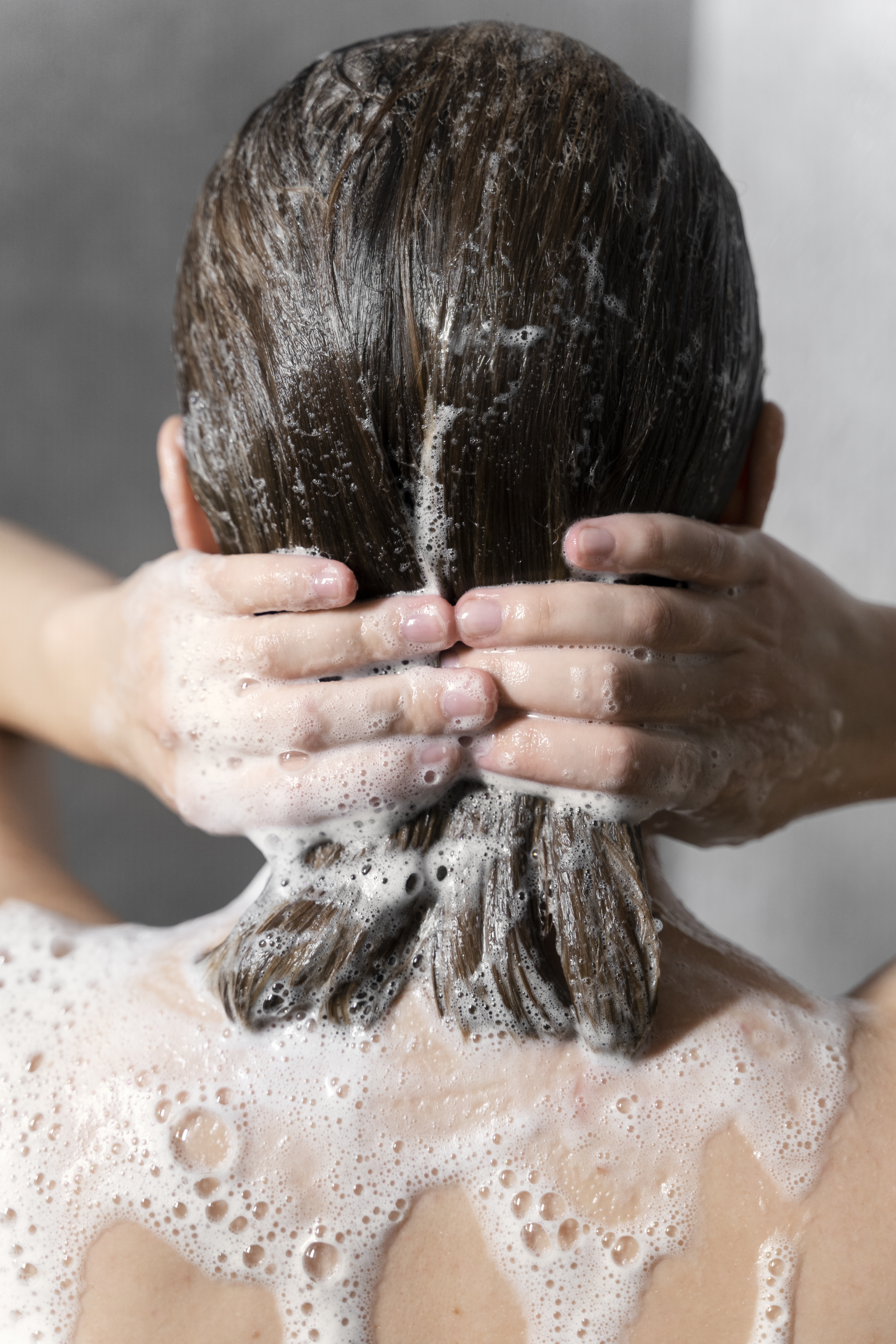 Bf096977fb3d9ef80701 young woman applying anti dandruff product