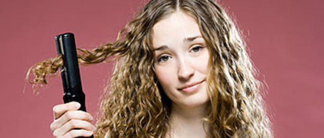 woman trying to straighten her hair