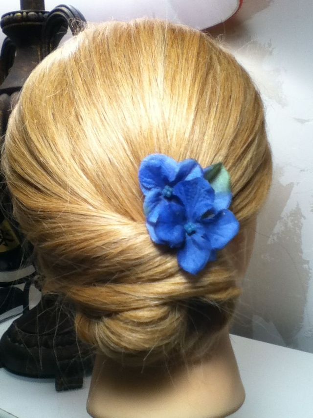 low twisted bun with a flower 