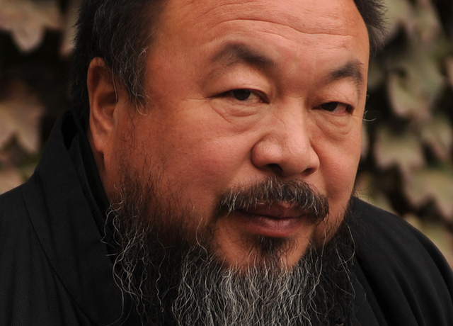 Chinese artist Ai Weiwei sits in the cou